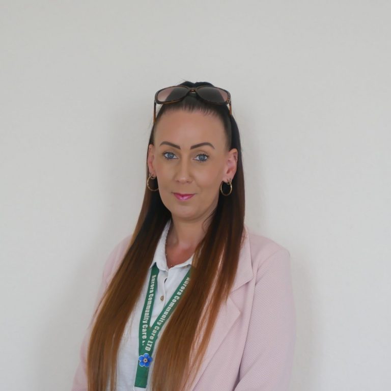 Jodi - Care Manager at Aurora Community Care A woman with long hair and sunglasses, wearing a patterned top and a black jacket.